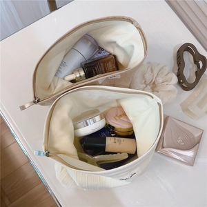 Top view of large striped fabric makeup bags showing spacious interior for storage