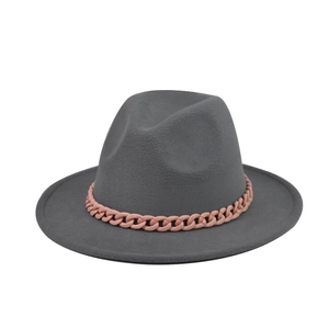 Detailed view of dark grey wide brim wool fedora hat featuring a pink chain decoration