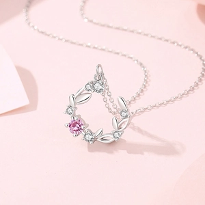 Elegant S925 silver necklace featuring a circular floral pendant with pink and white cubic zirconia