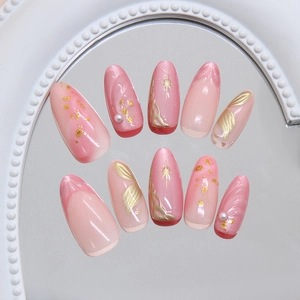 Pink cat-eye press-on nails with starburst accents and gold leaf irregular relief