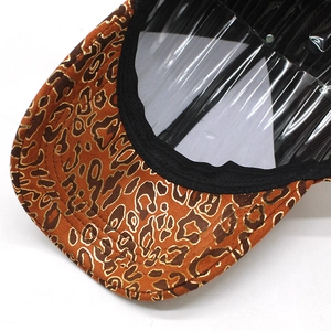 Close-up of leopard print baseball cap with brown fabric and gold line detailing