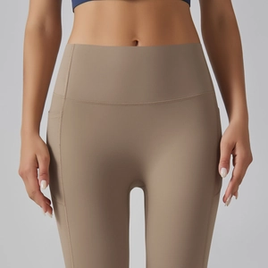 High-waisted yoga leggings with side pockets and compression fit in khaki brown color