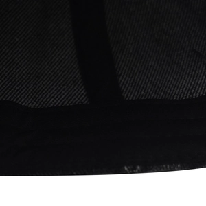 Macro detail of black washed denim fabric showing twill weave and durable stitched seams
