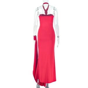 Detail of red backless halter maxi dress with ruched fabric and side ribbon decoration