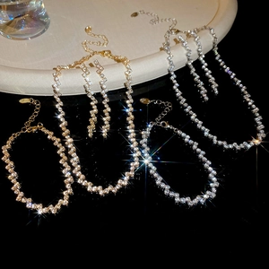 Detail of elegant gold and silver wavy jewelry sets with sparkling zircon stones