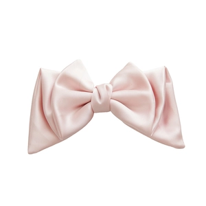 Pale pink satin bow hair clip with elegant pearl luster finish on white background