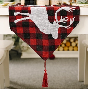 Christmas table runner with red black plaid pattern, white reindeer print and tassels