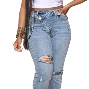 Women's light blue high waist ripped jeans with a unique asymmetrical crossover button waist