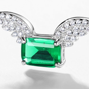 S925 silver necklace with emerald pendant and angel wings design on white background