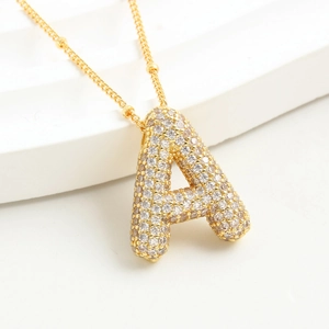 Close-up of golden letter A pendant with sparkling micro-pave cubic zirconia crystals