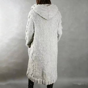 Macro view of cable-knit texture on long light gray hooded cardigan sweater