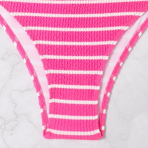 Detail of pink and white striped smocked fabric on a bikini bottom with ruffled texture
