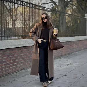 Classic brown long wool coat styled with black turtleneck and high-waist trousers