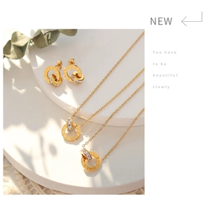 Detail of gold jewelry set featuring Roman numeral rings and cubic zirconia accents