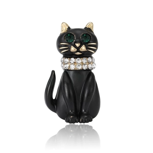 Elegant black enamel cat brooch with gold accents and green crystal eyes on white background