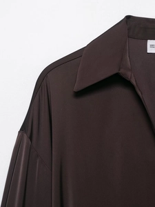 Detailed view of chocolate brown satin shirt collar and smooth fabric texture