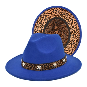 Detail of wool jazz hat with blue crown, leopard print brim, and silver star ornament