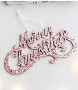 Close-up of pink glittery Merry Christmas hanging sign with white ribbon for tree decor