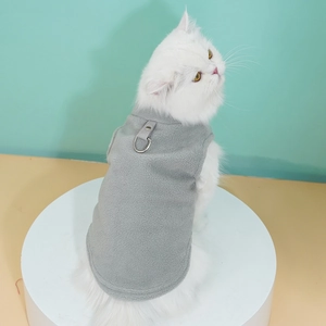 Close-up of gray fleece pet vest featuring a metal D-ring for leash attachment