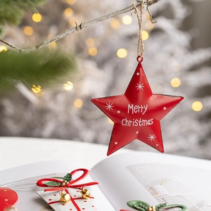 Red metal star Christmas ornament with Merry Christmas text on a festive tree background