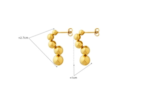 Detail view of gold beaded stud earrings with dimensions 2.7cm length and 1cm width
