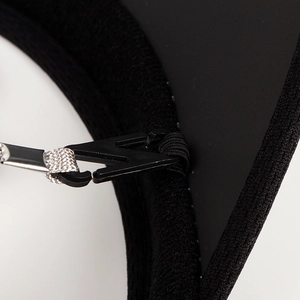 Detail of adjustable black plastic buckle and grey braided strap on UV sun visor hat