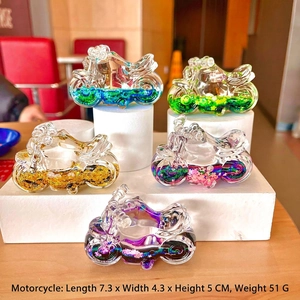 Macro detail of motorcycle drift bottle ornament with liquid quicksand and glitter inside