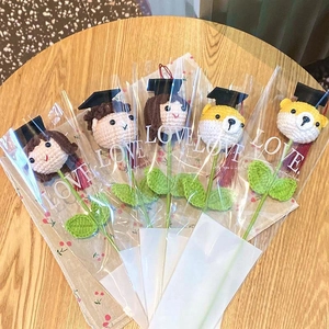 Handmade crochet graduation flower bouquets featuring dolls in black mortarboard caps