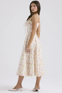 Detailed side view of floral sundress with sweetheart neckline and bow tie front design