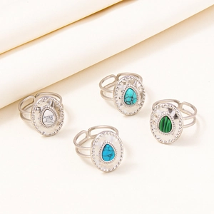 Detail of four vintage adjustable rings with pear-shaped stones in diverse colors