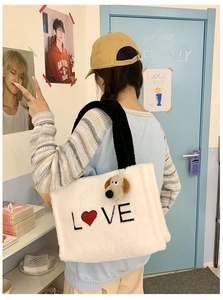 Close-up of white plush tote bag with LOVE embroidery and cute puppy charm detail