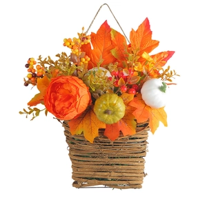 Autumn hanging basket with maple leaves and pumpkins for harvest festival decor