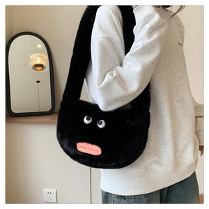Detail view of a black plush crossbody bag featuring cute cartoon eyes and pink lips