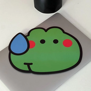 Cartoon green frog mouse pad with sweat drops on a silver laptop and white background