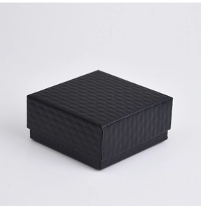 Macro shot of black square jewelry gift box with elegant diamond pattern texture