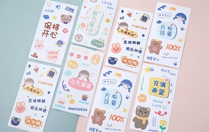 Flat lay of colorful cartoon bear and rabbit stationery stickers with motivational text