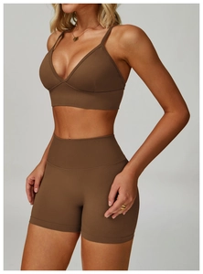 Detail of dark brown seamless ribbed yoga set with V-neck bra and high-waist shorts