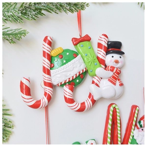 Macro view of Christmas JOY letter ornaments with candy cane and snowman decoration