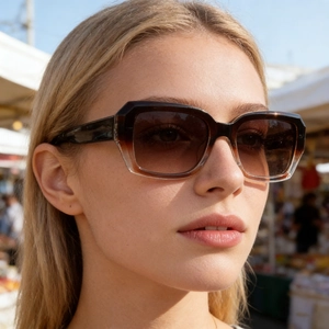 Close-up of square gradient tortoiseshell sunglasses worn by a male model outdoors