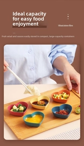 Action shot of dipping a dumpling into a heart-shaped wheat straw fiber sauce dish