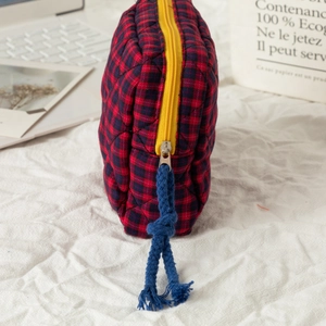 Quilted red and black plaid cotton pouch with yellow zipper and blue rope detail