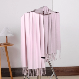 Detail of pink and mauve double-sided cashmere scarf showing soft texture and tassels