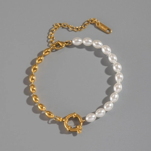 Detail view of 18K gold plated stainless steel bracelet with oval pearls and metal beads