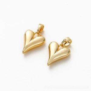 Macro detail of 18K gold-plated heart charms with polished finish for DIY jewelry