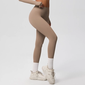 Side view of high-waisted earthy brown yoga leggings with matching long sleeve crop top