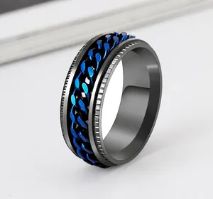 Close-up detail of black titanium steel ring with a rotatable blue chain link center