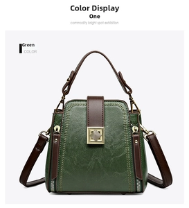 Detailed view of dark green and brown leather bucket bag with gold metal lock buckle