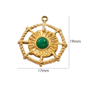 Macro view of a 14K gold plated sunburst charm with a green stone inlay and 19mm height