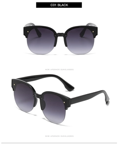 Close-up of black round cat eye sunglasses with purple gradient lenses and silver studs