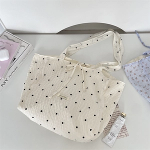 Detail of floral chiffon tote bag featuring drawstring closure and Sozakka brand label